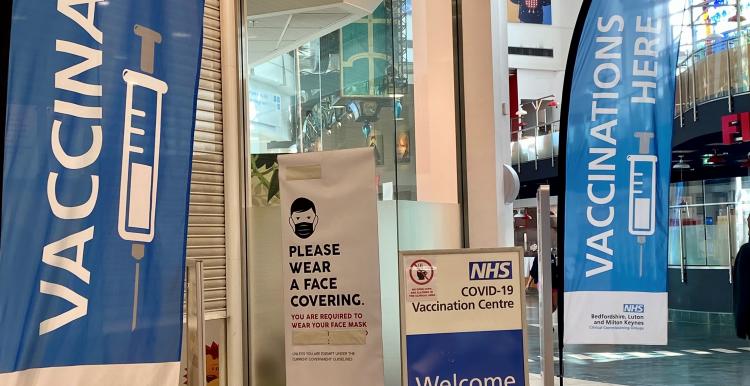 Vaccination here banner in Milton Keynes shopping centre