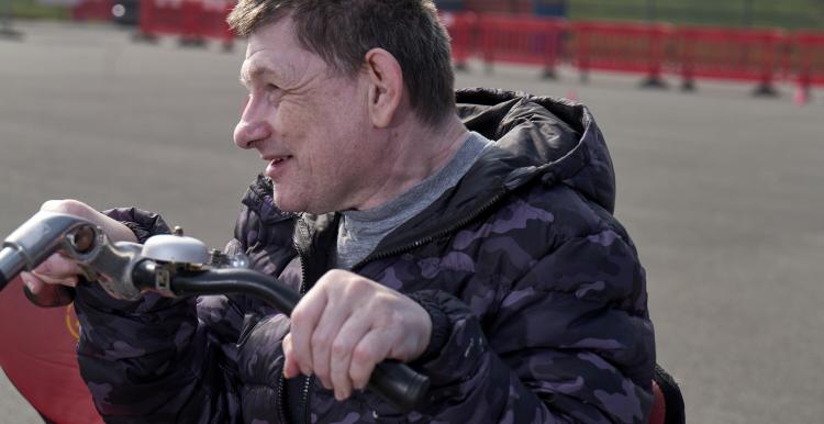 A man sitting on an adapted bike for disabled cyclists 