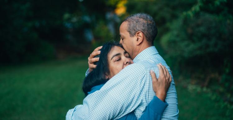 A man and a woman hugging 