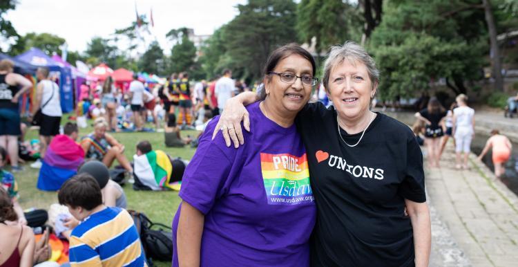 Two women at an event with one arm around her shoulder