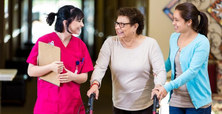 Elderly woman with family and carer