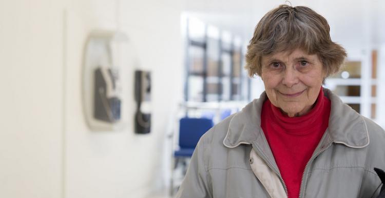 older woman alone in corridor