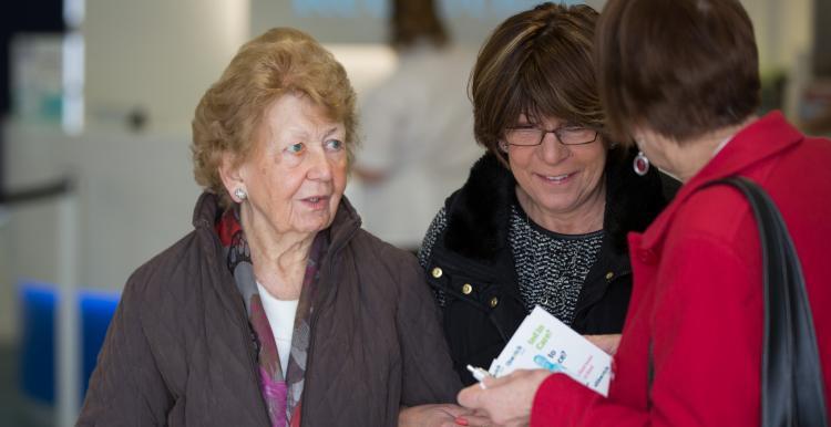 women talking to healthwatch representative women talking to healthwatch representative