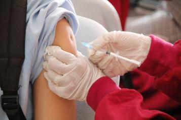 close up of an arm and a vaccination needle 