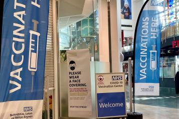 Vaccination here banner in Milton Keynes shopping centre