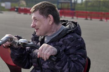 A man sitting on an adapted bike for disabled cyclists 