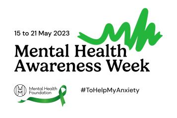 A mental health awrenss logo, black writing on a white background with a hashtag that reads to help my anxiety. A green ribbon is above the black text. 