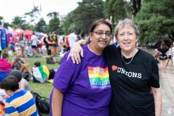 Two women at an event with one arm around her shoulder