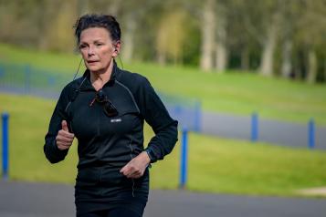 A woman outside running