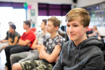 Teenage boys sitting in a room 