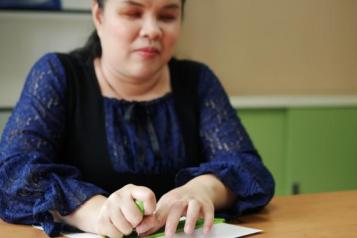 Blind woman using Braille