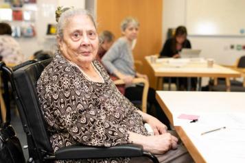 An elderly lady in a wheelchair