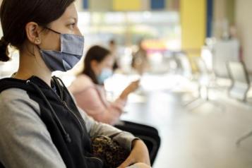 A young woman sits in a waiting room