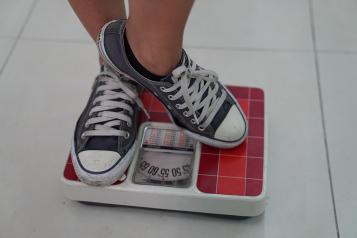 A pair of trainers standing on weighing scales 