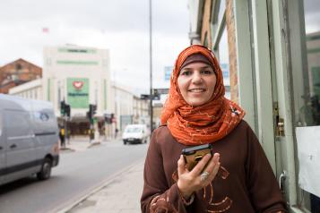 Woman holding her phone and smiling 