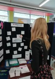 young person adding a post-it to an ideas board 